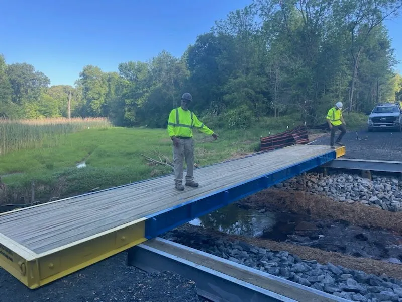 Single stress-laminated timber bridge panel seated on the concrete abutment
