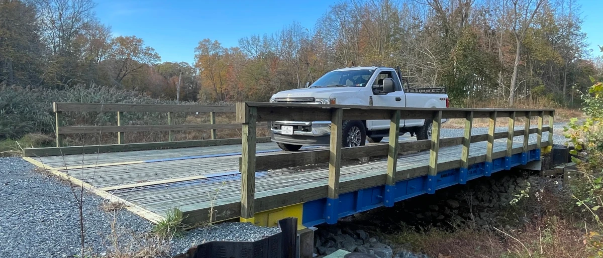 Truck crossing the completed three-panel timber bridge at the Lakeside at Trappe project, Maryland