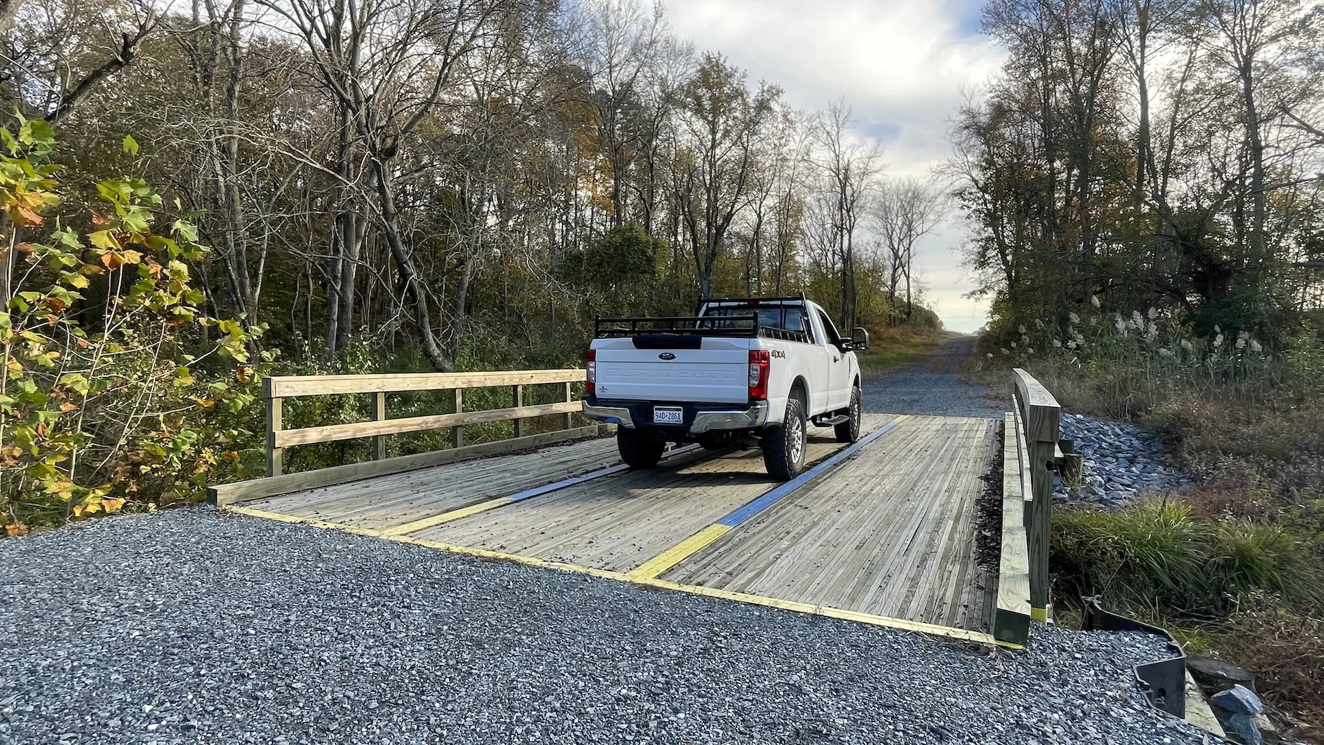 Pickup truck crossing an E&H timber bridge on a rural road