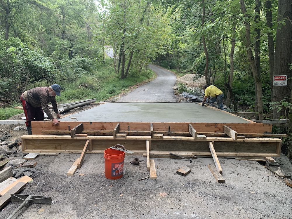 Workers finishing freshly poured concrete