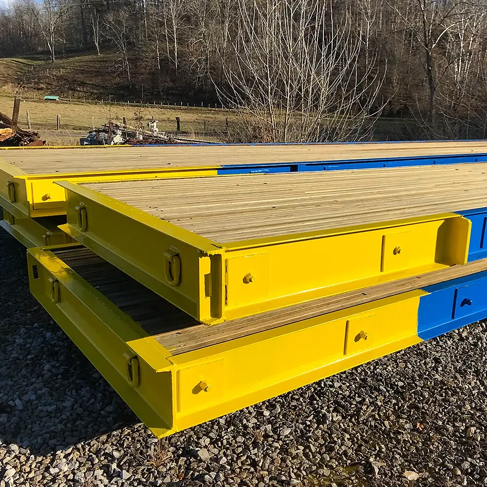 Bridge panels stacked showing end plates and D-rings for positioning.